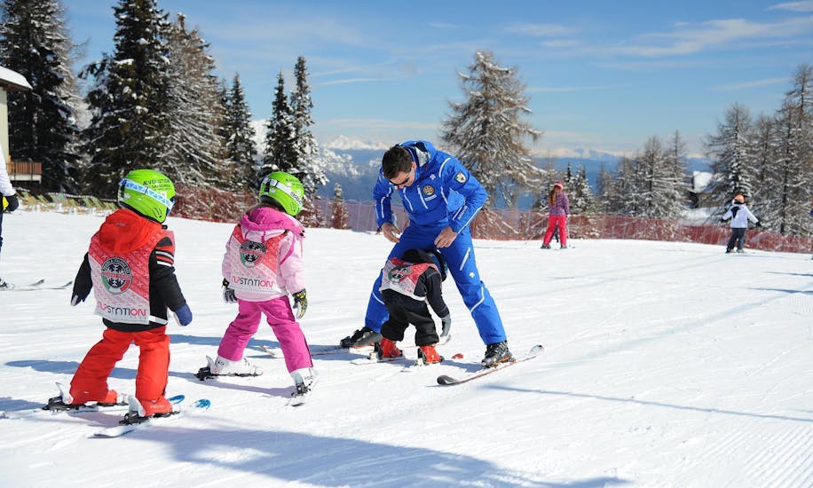 Private Ski Lessons for Kids - All Ages of Folgarida Dimaro Ski School are taking place, the children are training on the slopes of Val di Sole with the ski instructor.