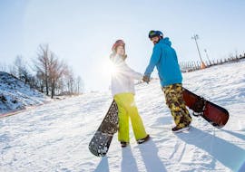 A couple takes part in the Private Snowboarding Lessons for Kids & Adults with Experience with Ski-fun.