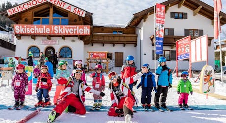 Medewerkers en hun leerlinging voor de Skiverhuur Skischule Ellmau Hartkaiser.